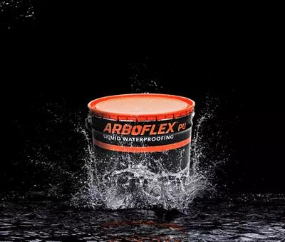 A tub of Arboflex PU waterproofing membrane splashing in a puddle